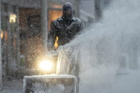 Man Blowing Snow