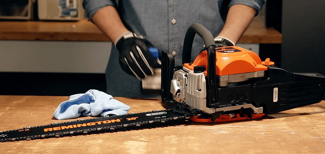 Chainsaw being used to apply chain oil to a chainsaw blade.