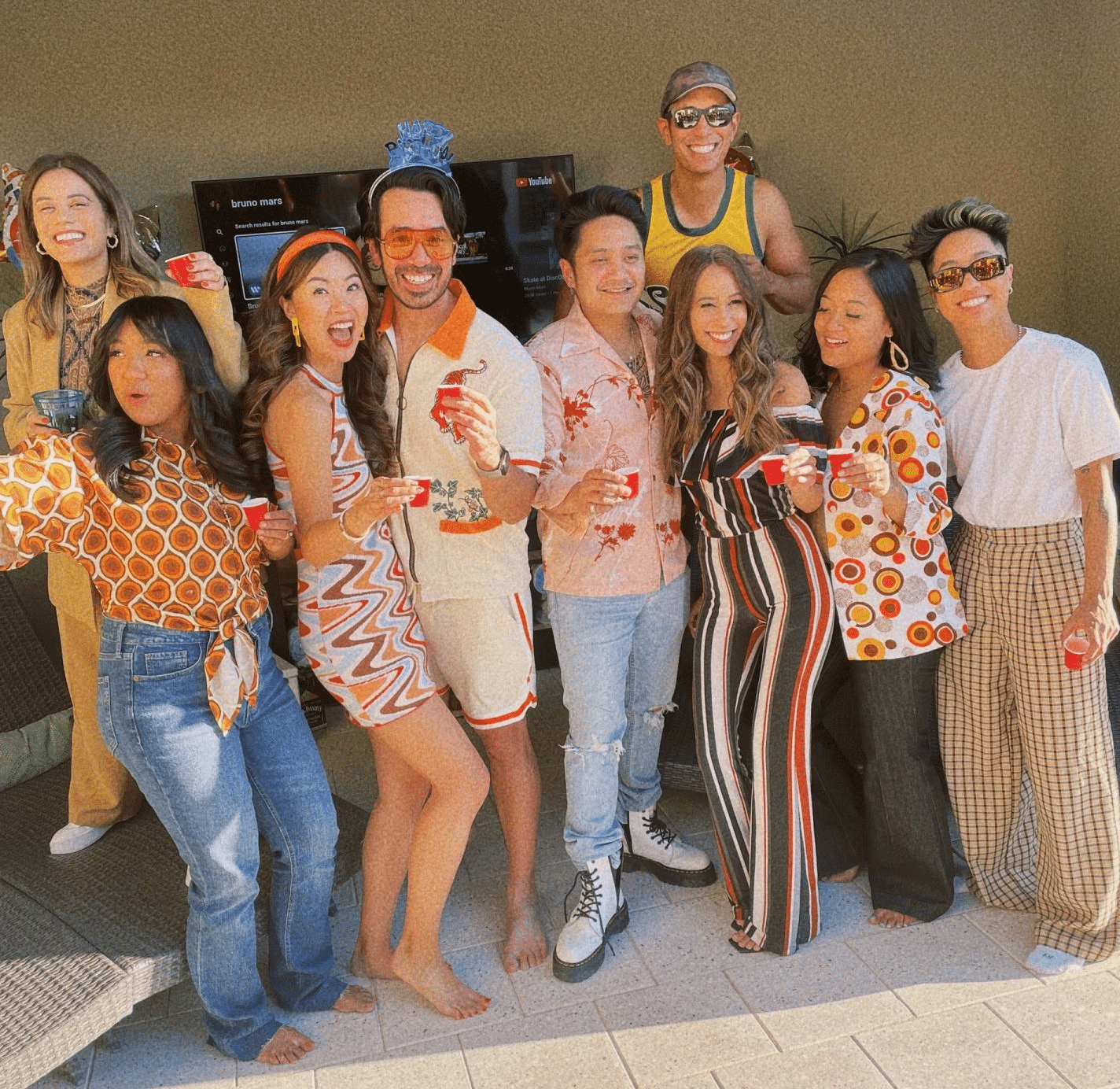 Party guests in 70s theme party attire